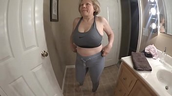 Fit granny stripping out of sports bra and yoga pants