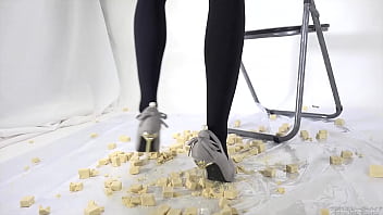 Beautiful legs woman slams food with legs