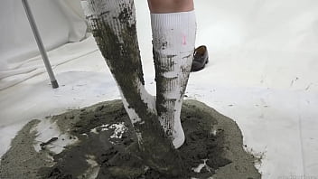 girl soiling her clean new socks with sand.
